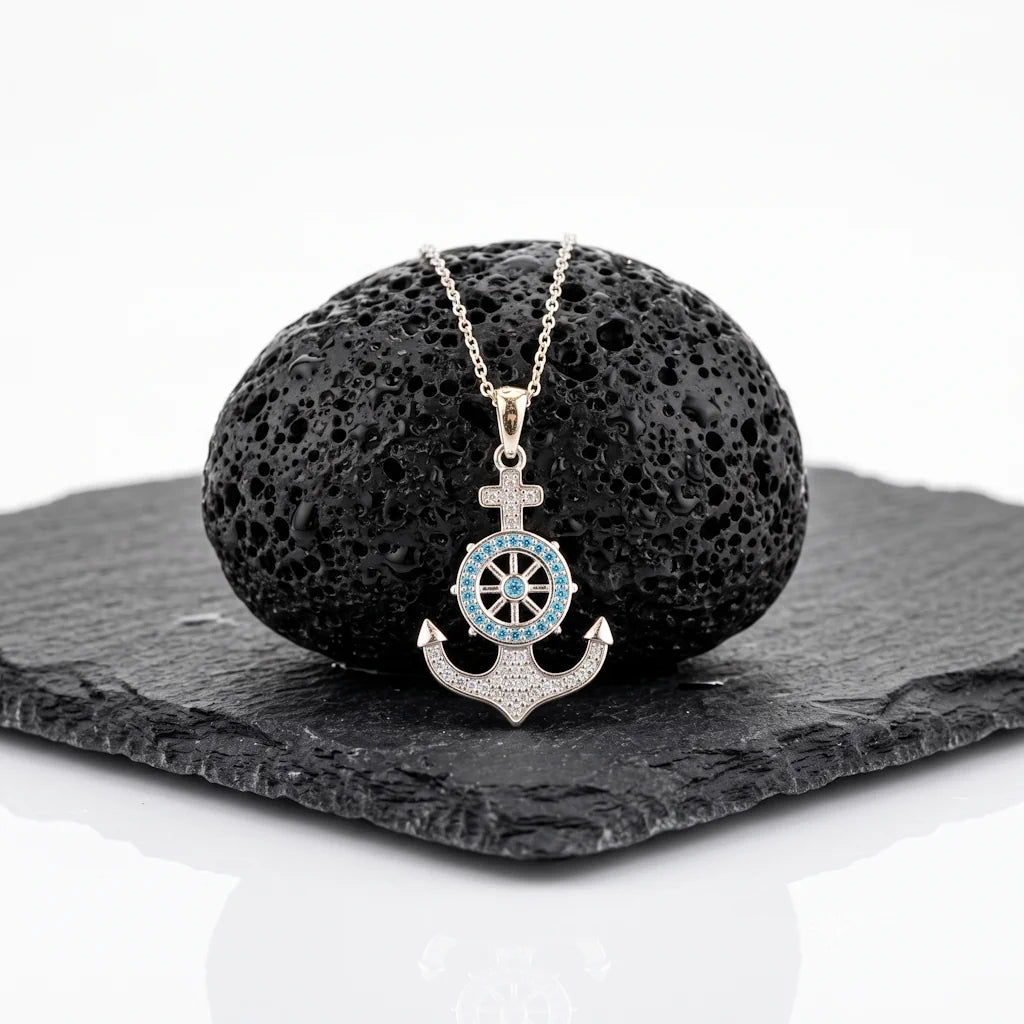 WAVERIDER ANCHOR – Exklusive Anker Kette mit blauen Zirkonia aus 925 Sterling Silber präsentiert auf schwarzem Lavastein von René Rose Jewelry
