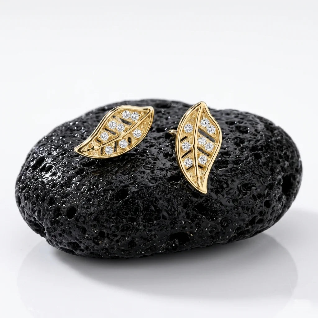 FOGLIA TRAFORATA – Filigrane Blatt Ohrringe aus 14k vergoldetem 925 Sterling Silber präsentiert auf schwarzem Lavastein von René Rose Jewelry