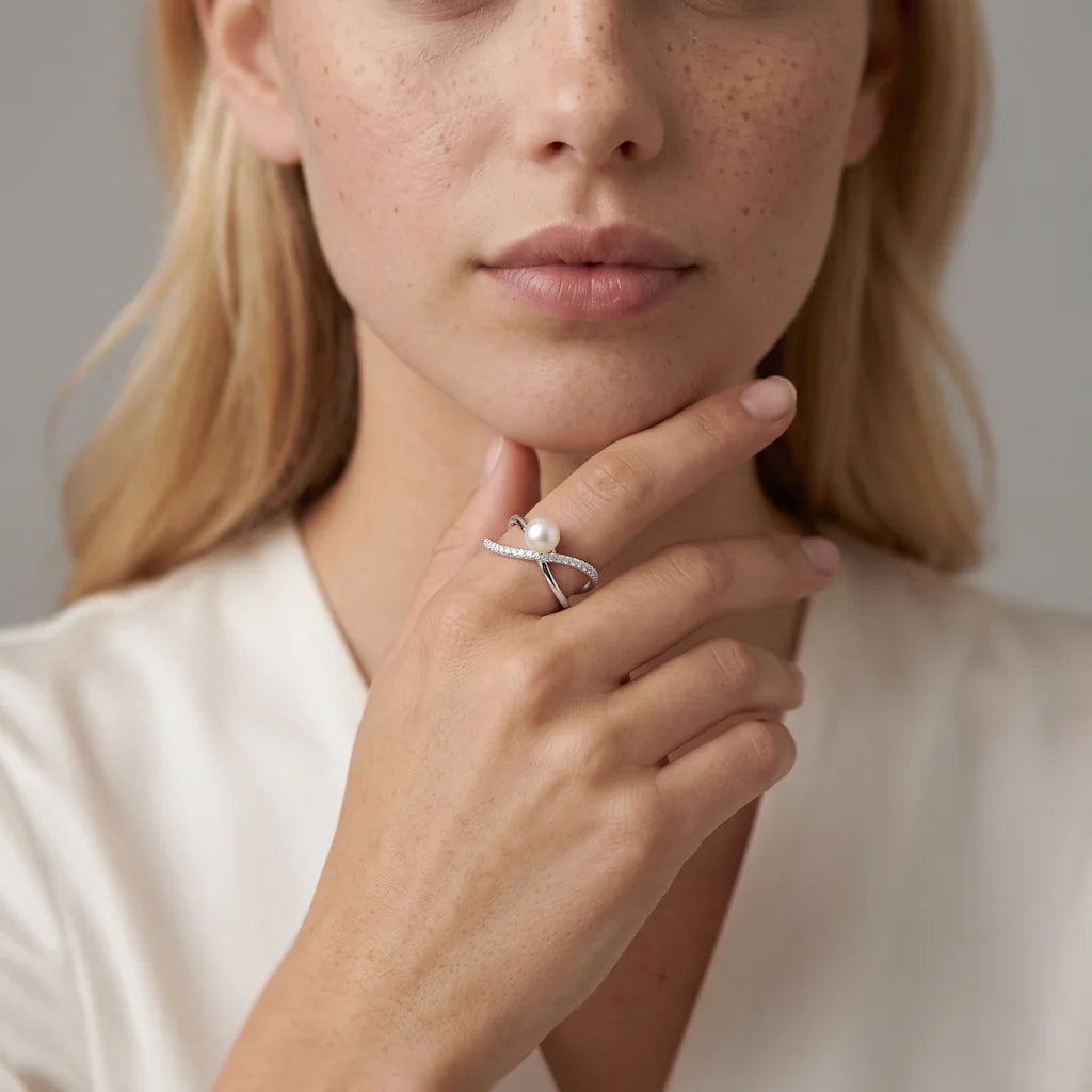 MAYA INFINITY – Opulenter silberner Crossover Ring mit Perle und Kristallen getragen an der Hand von René Rose Jewelry