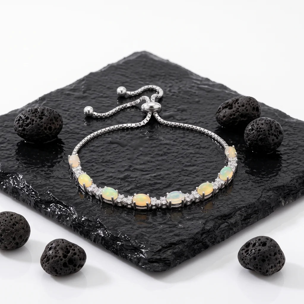 ISHANI OPALINE – Filigranes Tennisarmband mit echtem Opal aus rhodiniertem 925 Sterling Silber präsentiert auf dunkler Schieferplatte von René Rose Jewelry